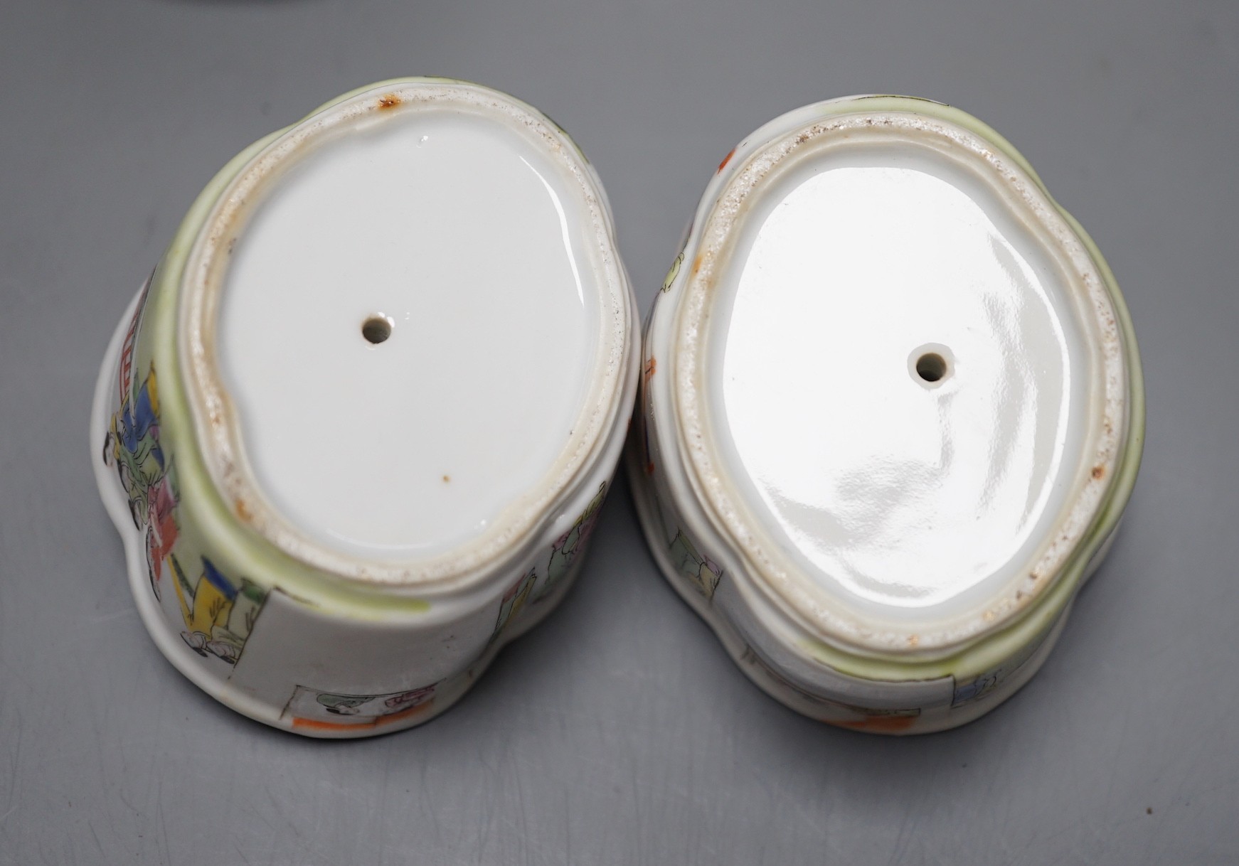 A pair of 19th century Chinese famille rose puzzle cups on stands, 8cm tall overall